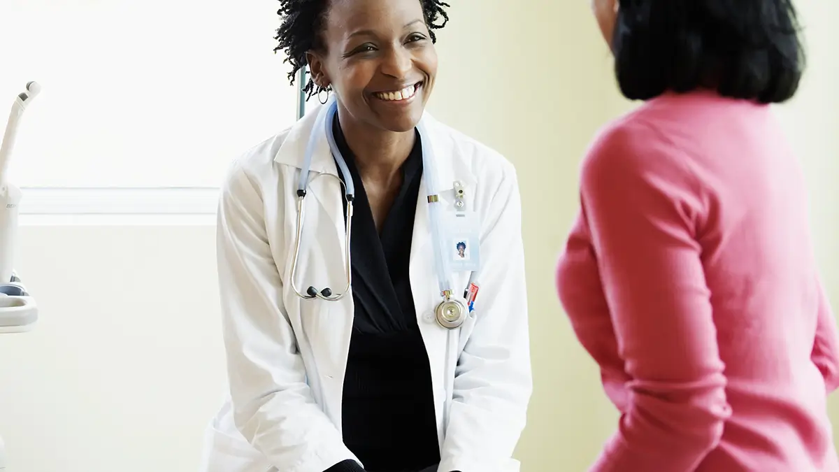 smiling doctor talking to an endometriosis patient